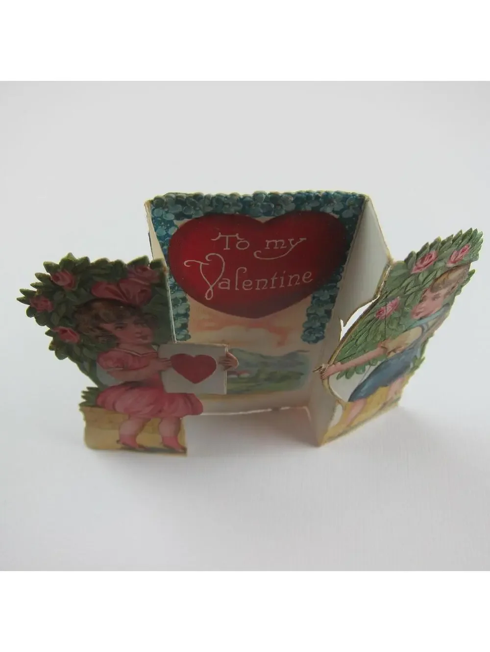 Vintage Valentine Boy Shoots Arrow Girl Pink Dress Holds Heart Target Mountains